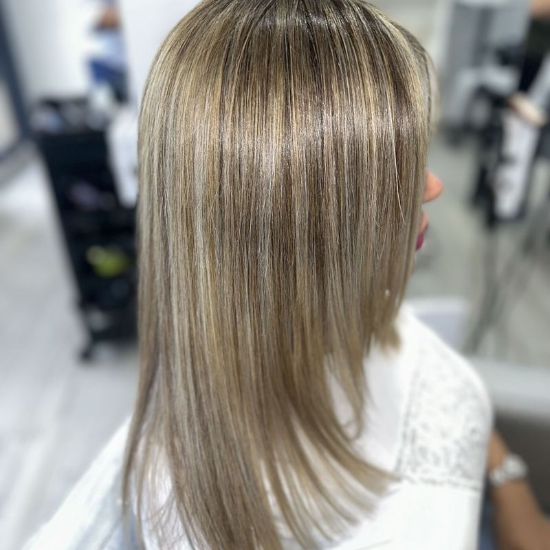 Client with sleek, straight hair after a smoothing hair botox treatment